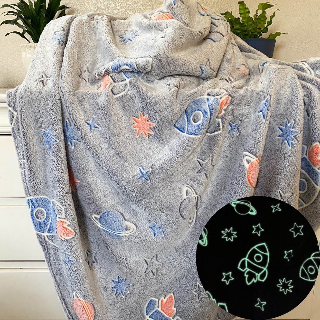blast off to bed with this fun grey glow in the dark kids throw blanket. has planets, rockships, and stars